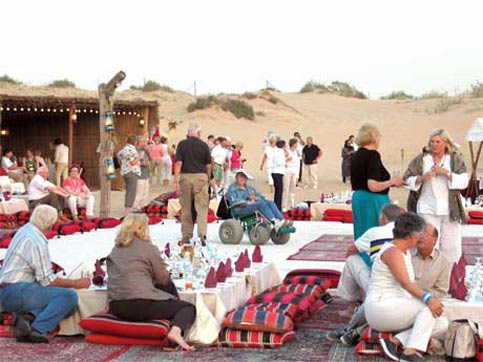 Travel for the disabled in the deserts around the United Arab Emirates is facilitated by using big tires on Nanc'ys wheel chair