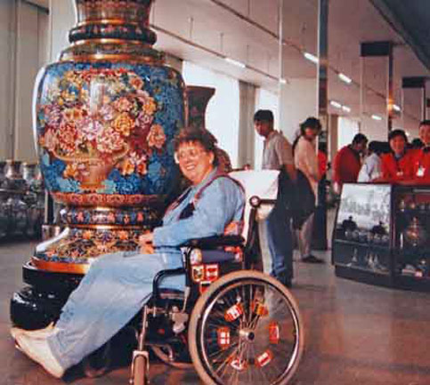 wheelchair disabled traveler admires art in china